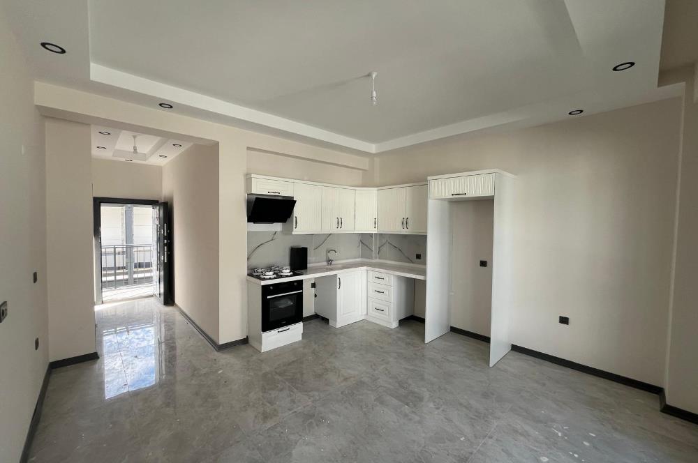 Güre Çamlıbel Zeytin Evleri’nde 1. Kat, Havuzlu, Bahçe Kullanımlı, Kapalı Otoparklı SATILIK DAİRE 1+1